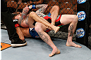 LAS VEGAS, NV - APRIL 13:   Cole Miller (bottom) attempts to submit Bart Palaszewski (top) in their featherweight fight at the Mandalay Bay Events Center  on April 13, 2013 in Las Vegas, Nevada.  (Photo by Josh Hedges/Zuffa LLC/Zuffa LLC via Getty Images)  *** Local Caption *** Cole Miller; Bart Palaszewski