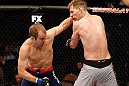 LAS VEGAS, NV - APRIL 13:   (L-R) Collin Hart punches Luke Barnatt in their middleweight fight at the Mandalay Bay Events Center  on April 13, 2013 in Las Vegas, Nevada.  (Photo by Josh Hedges/Zuffa LLC/Zuffa LLC via Getty Images)  *** Local Caption *** Luke Barnatt; Collin Hart