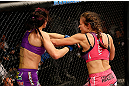 LAS VEGAS, NV - APRIL 13:   (R-L) Miesha Tate punches in their bantamweight fight at the Mandalay Bay Events Center  on April 13, 2013 in Las Vegas, Nevada.  (Photo by Josh Hedges/Zuffa LLC/Zuffa LLC via Getty Images)  *** Local Caption *** Miesha Tate; Cat Zingano