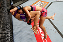 LAS VEGAS, NV - APRIL 13:   Miesha Tate (top) takes down Cat Zingano in their bantamweight fight at the Mandalay Bay Events Center  on April 13, 2013 in Las Vegas, Nevada.  (Photo by Josh Hedges/Zuffa LLC/Zuffa LLC via Getty Images)  *** Local Caption *** Miesha Tate; Cat Zingano