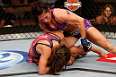 LAS VEGAS, NV - APRIL 13:   Cat Zingano (top) punches Miesha Tate in their bantamweight fight at the Mandalay Bay Events Center  on April 13, 2013 in Las Vegas, Nevada.  (Photo by Josh Hedges/Zuffa LLC/Zuffa LLC via Getty Images)  *** Local Caption *** Miesha Tate; Cat Zingano