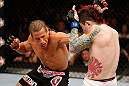 LAS VEGAS, NV - APRIL 13:   (L-R) Urijah Faber punches Scott Jorgensen in their bantamweight fight at the Mandalay Bay Events Center  on April 13, 2013 in Las Vegas, Nevada.  (Photo by Josh Hedges/Zuffa LLC/Zuffa LLC via Getty Images)  *** Local Caption *** Urijah Faber; Scott Jorgensen