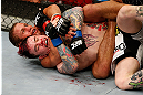 LAS VEGAS, NV - APRIL 13:   Urijah Faber (top) attempts to submit Scott Jorgensen in their bantamweight fight at the Mandalay Bay Events Center  on April 13, 2013 in Las Vegas, Nevada.  (Photo by Josh Hedges/Zuffa LLC/Zuffa LLC via Getty Images)  *** Local Caption *** Urijah Faber; Scott Jorgensen