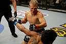 SAN JOSE, CA - APRIL 20:  T.J. Dillashaw (top) punches Hugo Viana in their bantamweight bout during the UFC on FOX event at the HP Pavilion on April 20, 2013 in San Jose, California.  (Photo by Ezra Shaw/Zuffa LLC/Zuffa LLC via Getty Images)  *** Local Caption *** T.J. Dillashaw; Hugo Viana