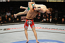 SAN JOSE, CA - APRIL 20:   Jorge Masvidal (red shorts) lifts Tim Means into the air in their lightweight bout during the UFC on FOX event at the HP Pavilion on April 20, 2013 in San Jose, California.  (Photo by Ezra Shaw/Zuffa LLC/Zuffa LLC via Getty Images)  *** Local Caption *** Tim Means; Jorge Masvidal
