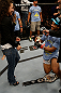 SAN JOSE, CA - APRIL 20:   Benson Henderson (right) proposes to his girlfirend Maria Magana (left) during the UFC on FOX event at the HP Pavilion on April 20, 2013 in San Jose, California.  (Photo by Ezra Shaw/Zuffa LLC/Zuffa LLC via Getty Images)  *** Local Caption *** Benson Henderson; Maria Magana
