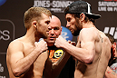 NEWARK, NJ - APRIL 26:   (L-R) Opponents Bryan Caraway and Johny Bedford face off during the UFC 159 weigh-in event at the Prudential Center on April 26, 2013 in Newark, New Jersey.  (Photo by Josh Hedges/Zuffa LLC/Zuffa LLC via Getty Images)