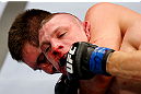 NEWARK, NJ - APRIL 27:  Kurt Holobaugh tries to get loose from Steven Siler in their featherweight bout during the UFC 159 event at the Prudential Center on April 27, 2013 in Newark, New Jersey.  (Photo by Al Bello/Zuffa LLC/Zuffa LLC Via Getty Images)