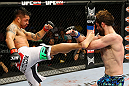 NEWARK, NJ - APRIL 27:  Cody McKenzie (R) blocks a kick from Leonard Garcia (L) in their featherweight bout during the UFC 159 event at the Prudential Center on April 27, 2013 in Newark, New Jersey.  (Photo by Al Bello/Zuffa LLC/Zuffa LLC Via Getty Images)