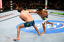 NEWARK, NJ - APRIL 27:  Cody McKenzie (L) and Leonard Garcia (R) exchange punches in their featherweight bout during the UFC 159 event at the Prudential Center on April 27, 2013 in Newark, New Jersey.  (Photo by Al Bello/Zuffa LLC/Zuffa LLC Via Getty Images)