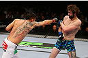 NEWARK, NJ - APRIL 27:  Leonard Garcia (L) throws a punch against Cody McKenzie (R) in their featherweight bout during the UFC 159 event at the Prudential Center on April 27, 2013 in Newark, New Jersey.  (Photo by Al Bello/Zuffa LLC/Zuffa LLC Via Getty Images)