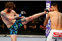 NEWARK, NJ - APRIL 27: Cody McKenzie (L) kicks Leonard Garcia (R) in their featherweight bout during the UFC 159 event at the Prudential Center on April 27, 2013 in Newark, New Jersey.  (Photo by Al Bello/Zuffa LLC/Zuffa LLC Via Getty Images)