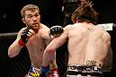 NEWARK, NJ - APRIL 27:   (L-R) Bryan Caraway punches Johny Bedford in their bantamweight fight during the UFC 159 event at the Prudential Center on April 27, 2013 in Newark, New Jersey.  (Photo by Josh Hedges/Zuffa LLC/Zuffa LLC via Getty Images)