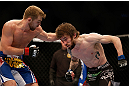 NEWARK, NJ - APRIL 27:   (L-R) Bryan Caraway punches Johny Bedford in their bantamweight fight during the UFC 159 event at the Prudential Center on April 27, 2013 in Newark, New Jersey.  (Photo by Josh Hedges/Zuffa LLC/Zuffa LLC via Getty Images)