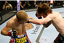 NEWARK, NJ - APRIL 27: Johnny Bedford (R) punches Bryan Caraway (L) in their bantamweight bout during the UFC 159 event at the Prudential Center on April 27, 2013 in Newark, New Jersey.  (Photo by Al Bello/Zuffa LLC/Zuffa LLC Via Getty Images)