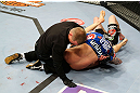 NEWARK, NJ - APRIL 27:  Bryan Caraway submits Johnny Bedford with a  guillotine choke as the referee calls the match in their bantamweight bout during the UFC 159 event at the Prudential Center on April 27, 2013 in Newark, New Jersey.  (Photo by Al Bello/Zuffa LLC/Zuffa LLC Via Getty Images)