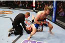 NEWARK, NJ - APRIL 27:  Bryan Caraway (R) celebrates winning by submission (guillotine choke) against Johnny Bedford (C) in their bantamweight bout during the UFC 159 event at the Prudential Center on April 27, 2013 in Newark, New Jersey.  (Photo by Al Bello/Zuffa LLC/Zuffa LLC Via Getty Images)