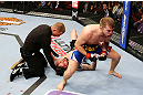 NEWARK, NJ - APRIL 27:  Bryan Caraway (R) celebrates winning by submission (guillotine choke) against Johnny Bedford (C) in their bantamweight bout during the UFC 159 event at the Prudential Center on April 27, 2013 in Newark, New Jersey.  (Photo by Al Bello/Zuffa LLC/Zuffa LLC Via Getty Images)