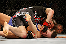 NEWARK, NJ - APRIL 27:   Sara McMann (top) punches Sheila Gaff in their bantamweight fight during the UFC 159 event at the Prudential Center on April 27, 2013 in Newark, New Jersey.  (Photo by Josh Hedges/Zuffa LLC/Zuffa LLC via Getty Images)
