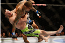 NEWARK, NJ - APRIL 27:   (L-R) Rustam Khabilov takes down Yancy Medeiros in their lightweight fight during the UFC 159 event at the Prudential Center on April 27, 2013 in Newark, New Jersey.  (Photo by Josh Hedges/Zuffa LLC/Zuffa LLC via Getty Images)