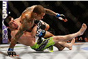 NEWARK, NJ - APRIL 27:   (L-R) Rustam Khabilov takes down Yancy Medeiros in their lightweight fight during the UFC 159 event at the Prudential Center on April 27, 2013 in Newark, New Jersey.  (Photo by Josh Hedges/Zuffa LLC/Zuffa LLC via Getty Images)