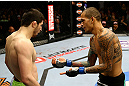 NEWARK, NJ - APRIL 27: Yancy Medeiros (R) shows his injury to Rustam Khabilov (L) of Russia after the stoppage of their lightweight bout during the UFC 159 event at the Prudential Center on April 27, 2013 in Newark, New Jersey.  (Photo by Al Bello/Zuffa LLC/Zuffa LLC Via Getty Images)