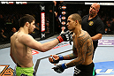 NEWARK, NJ - APRIL 27:  Yancy Medeiros (R) shows his injury to Rustam Khabilov (L) of Russia after the stoppage of their lightweight bout during the UFC 159 event at the Prudential Center on April 27, 2013 in Newark, New Jersey.  (Photo by Al Bello/Zuffa LLC/Zuffa LLC Via Getty Images)
