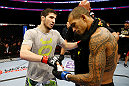 NEWARK, NJ - APRIL 27:  (L-R) Rustam Khabilov of Russia shakes hands with Yancy Medeiros after winning by TKO (Thumb Injury) during their lightweight bout during the UFC 159 event at the Prudential Center on April 27, 2013 in Newark, New Jersey.  (Photo by Al Bello/Zuffa LLC/Zuffa LLC Via Getty Images)