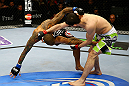 NEWARK, NJ - APRIL 27: Rustam Khabilov (R) of Russia grabs the leg of Yancy Medeiros (L) in their lightweight bout during the UFC 159 event at the Prudential Center on April 27, 2013 in Newark, New Jersey.  (Photo by Al Bello/Zuffa LLC/Zuffa LLC Via Getty Images)