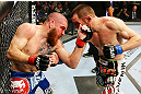 NEWARK, NJ - APRIL 27: (L-R) Jim Miller and Pat Healy exchange punches in their lightweight bout during the UFC 159 event at the Prudential Center on April 27, 2013 in Newark, New Jersey.  (Photo by Al Bello/Zuffa LLC/Zuffa LLC Via Getty Images)