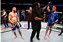 NEWARK, NJ - APRIL 27:  Referee Herb Dean (C) raises the arm of winner Pat Healy (R) after defeating Jim Miller (L) by Technical Submission (rear-naked choke) in their lightweight bout during the UFC 159 event at the Prudential Center on April 27, 2013 in Newark, New Jersey.  (Photo by Al Bello/Zuffa LLC/Zuffa LLC Via Getty Images)
