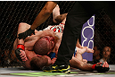 NEWARK, NJ - APRIL 27:   (L-R) Pat Healy secures a rear choke submission against Jim Miller in their lightweight fight during the UFC 159 event at the Prudential Center on April 27, 2013 in Newark, New Jersey.  (Photo by Josh Hedges/Zuffa LLC/Zuffa LLC via Getty Images)