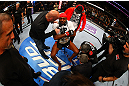 NEWARK, NJ - APRIL 27:  Jon Jones (C) has his broken toe tended to while he is interviewed by Joe Rogan (R) after winning by knockout in round one against Chael Sonnen in their light heavyweight championship bout during the UFC 159 event at the Prudential Center on April 27, 2013 in Newark, New Jersey.  (Photo by Al Bello/Zuffa LLC/Zuffa LLC Via Getty Images)