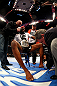 NEWARK, NJ - APRIL 27:  Jon Jones (C) has his broken toe tended to while he is interviewed by Joe Rogan (R) after winning by knockout in round one against Chael Sonnen in their light heavyweight championship bout during the UFC 159 event at the Prudential Center on April 27, 2013 in Newark, New Jersey.  (Photo by Al Bello/Zuffa LLC/Zuffa LLC Via Getty Images)