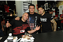 LAS VEGAS, NV - JULY 7:   (L-R) Matt Serra, Frank Mir and Dan Hardy sign autographs during the UFC Fan Expo at the Mandalay Bay Convention Center on July 7, 2012 in Las Vegas, Nevada.  (Photo by Al Powers/Zuffa LLC/Zuffa LLC via Getty Images)  *** Local Caption ***