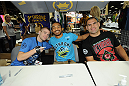LAS VEGAS, NV - JULY 06:  (L-R) Michael McDonald, Benson Henderson and Cain Velasquez pose for fans at the UFC Fan Expo on July 6, 2012 in Las Vegas, Nevada. (Photo by Al Powers /Zuffa LLC/Zuffa LLC via Getty Images)