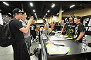 LAS VEGAS, NV - JULY 06:  UFC bantamweight champion Dominick Cruz poses with a fan at the UFC Fan Expo on July 6, 2012 in Las Vegas, Nevada. (Photo by Al Powers /Zuffa LLC/Zuffa LLC via Getty Images)