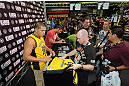 LAS VEGAS, NV - JULY 7:   Anthony Pettis and Sam Stout sign autographs during the UFC Fan Expo at the Mandalay Bay Convention Center on July 7, 2012 in Las Vegas, Nevada.  (Photo by Al Powers/Zuffa LLC/Zuffa LLC via Getty Images)  *** Local Caption ***