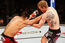 JARAGUA DO SUL, BRAZIL - MAY 18: (R-L) Evan Dunham punches Rafael dos Anjos in their lightweight bout during the UFC on FX event on May 18, 2013 at Arena Jaragua in Jaragua do Sul, Santa Catarina, Brazil. (Photo by Josh Hedges/Zuffa LLC/Zuffa LLC via Getty Images)