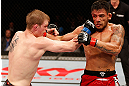 JARAGUA DO SUL, BRAZIL - MAY 18: (L-R) Evan Dunham punches Rafael dos Anjos in their lightweight bout during the UFC on FX event on May 18, 2013 at Arena Jaragua in Jaragua do Sul, Santa Catarina, Brazil. (Photo by Josh Hedges/Zuffa LLC/Zuffa LLC via Getty Images)