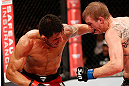JARAGUA DO SUL, BRAZIL - MAY 18:   (L-R) Rafael dos Anjos punches Evan Dunham in their lightweight bout during the UFC on FX event on May 18, 2013 at Arena Jaragua in Jaragua do Sul, Santa Catarina, Brazil.  (Photo by Josh Hedges/Zuffa LLC/Zuffa LLC via Getty Images)