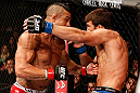 JARAGUA DO SUL, BRAZIL - MAY 18:   (L-R) Vitor Belfort punches Luke Rockhold in their middleweight bout during the UFC on FX event on May 18, 2013 at Arena Jaragua in Jaragua do Sul, Santa Catarina, Brazil.  (Photo by Josh Hedges/Zuffa LLC/Zuffa LLC via Getty Images)