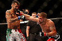 LAS VEGAS, NV - MAY 25:   (R-L) Jeremy Stephens punches Estevan Payan in their featherweight bout during UFC 160 at the MGM Grand Garden Arena on May 25, 2013 in Las Vegas, Nevada.  (Photo by Josh Hedges/Zuffa LLC/Zuffa LLC via Getty Images)  *** Local Caption *** Jeremy Stephens; Estevan Payan
