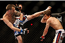 LAS VEGAS, NV - MAY 25:   (L-R) George Roop kicks Brian Bowles in their bantamweight bout during UFC 160 at the MGM Grand Garden Arena on May 25, 2013 in Las Vegas, Nevada.  (Photo by Josh Hedges/Zuffa LLC/Zuffa LLC via Getty Images)  *** Local Caption *** Brian Bowles; George Roop