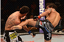 LAS VEGAS, NV - MAY 25:   (R-L) Dennis Bermudez kicks Max Holloway in their featherweight bout during UFC 160 at the MGM Grand Garden Arena on May 25, 2013 in Las Vegas, Nevada.  (Photo by Donald Miralle/Zuffa LLC/Zuffa LLC via Getty Images)  *** Local Caption *** Dennis Bermudez; Max Holloway