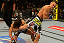 LAS VEGAS, NV - MAY 25:   Max Holloway (right) kicks Dennis Bermudez in their featherweight bout during UFC 160 at the MGM Grand Garden Arena on May 25, 2013 in Las Vegas, Nevada.  (Photo by Donald Miralle/Zuffa LLC/Zuffa LLC via Getty Images)  *** Local Caption *** Dennis Bermudez; Max Holloway