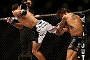 LAS VEGAS, NV - MAY 25:   (L-R) Max Holloway kicks Dennis Bermudez in their featherweight bout during UFC 160 at the MGM Grand Garden Arena on May 25, 2013 in Las Vegas, Nevada.  (Photo by Josh Hedges/Zuffa LLC/Zuffa LLC via Getty Images)  *** Local Caption *** Dennis Bermudez; Max Holloway