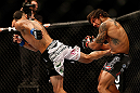 LAS VEGAS, NV - MAY 25:   (L-R) Max Holloway kicks Dennis Bermudez in their featherweight bout during UFC 160 at the MGM Grand Garden Arena on May 25, 2013 in Las Vegas, Nevada.  (Photo by Josh Hedges/Zuffa LLC/Zuffa LLC via Getty Images)  *** Local Caption *** Dennis Bermudez; Max Holloway