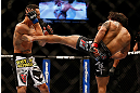 LAS VEGAS, NV - MAY 25:   (R-L) Dennis Bermudez kicks Max Holloway in their featherweight bout during UFC 160 at the MGM Grand Garden Arena on May 25, 2013 in Las Vegas, Nevada.  (Photo by Josh Hedges/Zuffa LLC/Zuffa LLC via Getty Images)  *** Local Caption *** Dennis Bermudez; Max Holloway