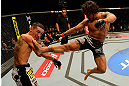 LAS VEGAS, NV - MAY 25:   (R-L) Dennis Bermudez kicks Max Holloway in their featherweight bout during UFC 160 at the MGM Grand Garden Arena on May 25, 2013 in Las Vegas, Nevada.  (Photo by Donald Miralle/Zuffa LLC/Zuffa LLC via Getty Images)  *** Local Caption *** Dennis Bermudez; Max Holloway